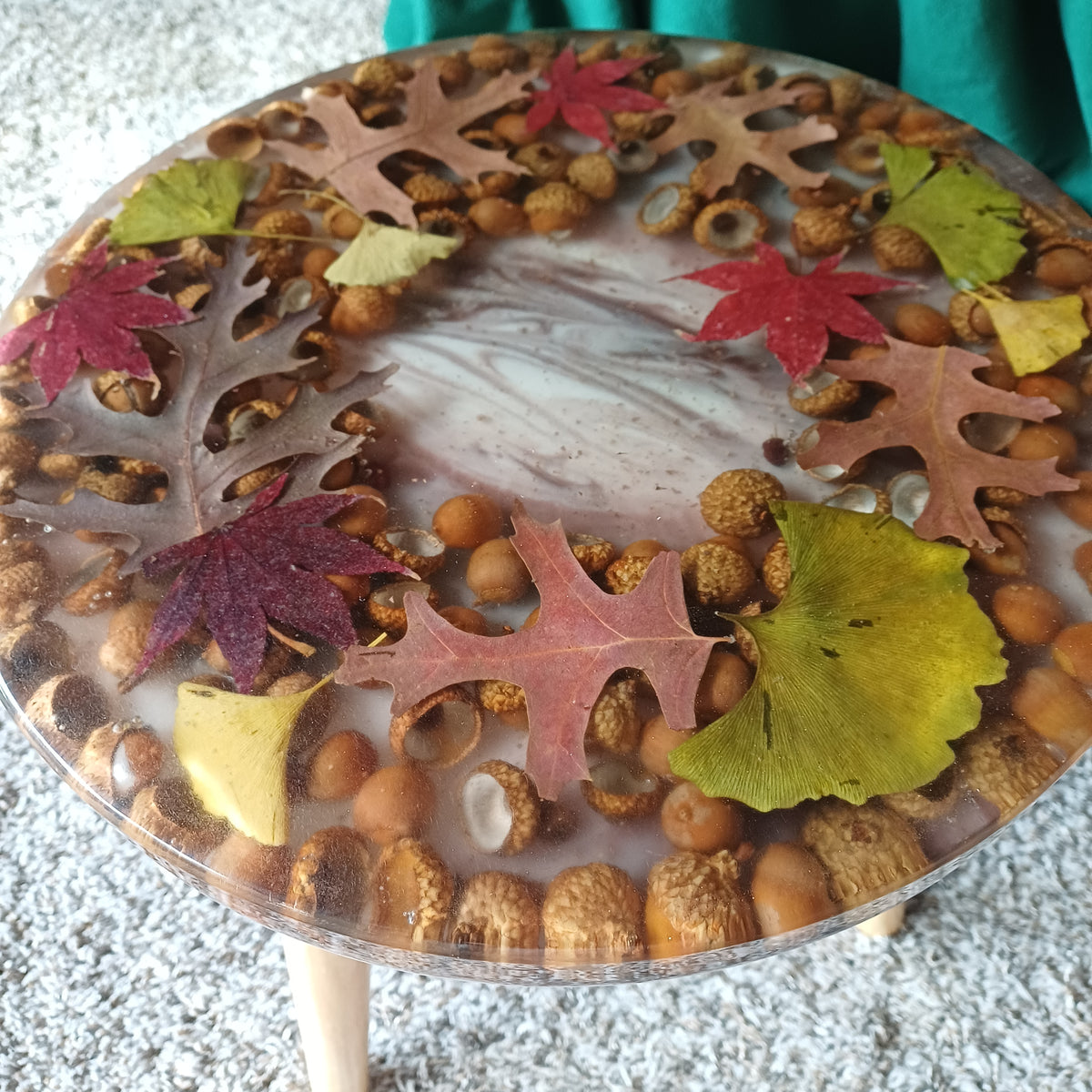 Handmade epoxy accent table with dried autumn leaves and acorns, tapered wooden legs, ready to ship